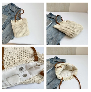 Detail view of cream crochet bag with floral trim and brown leather handles