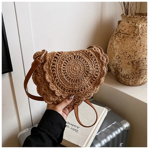 Detailed wave edge texture on a woven saddle bag with premium brown leather strap