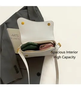 Internal view of the white pebble leather saddle bag showing phone and wallet storage