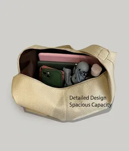 Macro view showing large capacity interior of beige tote bag with daily essentials
