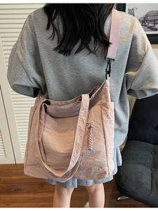Morandi pink large nylon tote bag with wide adjustable strap worn by model