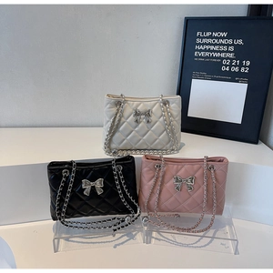 Quilted chain bags in white, black and pink with metal bow detail and leather straps