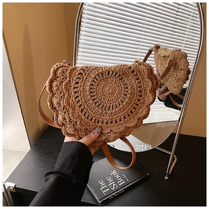 Detail of handwoven brown saddle bag showing circular knit texture and wavy scalloped edges