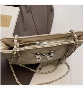 Close-up of smooth metal zipper and inner compartment of the quilted chain crossbody bag
