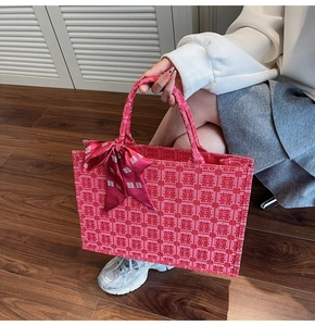 Detail of red wedding tote bag with Xi character jacquard and elegant silk scarf