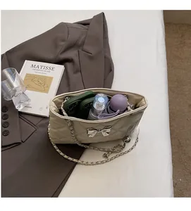 Spacious interior of beige quilted chain bag showing capacity for phones and cosmetics