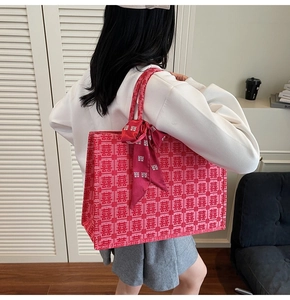 Pink Chinese wedding tote bag with Xi characters and ribbon detail shown on shoulder