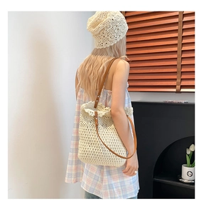 Close-up of woven shoulder bag with wavy edges and matching crochet beret hat