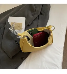 Interior view showing large capacity of the yellow crescent bag with leather texture