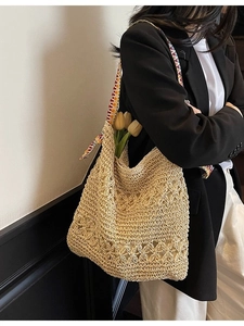 Handmade crochet shoulder bag with hollow floral patterns and colorful striped strap