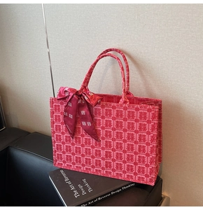 Macro shot of red jacquard wedding tote bag with Xi character texture and silk scarf