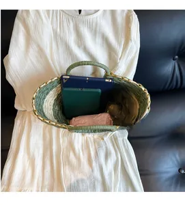 Detail showing the spacious interior of the two-tone straw bag with tablet and umbrella