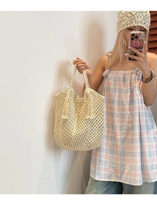 Large beige hand-woven crochet tote bag with fringe tassels for beach holiday style