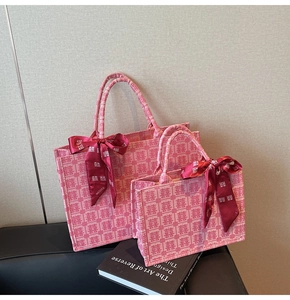 Detail of pink bridal tote bags with traditional Xi pattern and decorative silk bows