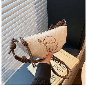 Vue détaillée de la texture du tissu tissé et broderie de chien mignon sur le sac