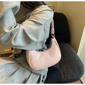 Close-up of pink hobo bag with lychee grain texture and silver zipper detail