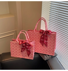 Detail of pink Chinese wedding tote bags with double happiness prints and red bows
