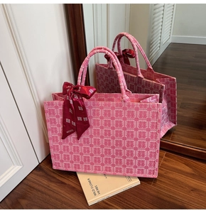 Detail of pink bridal tote bag with red Xi characters and decorative silk scarf detail