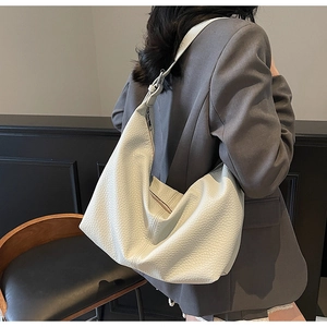 Detail of white pebble grain leather hobo bag showing soft half-moon shape and stitching
