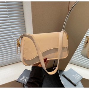 Detailed close-up of premium white pebbled leather texture on minimalist shoulder bag