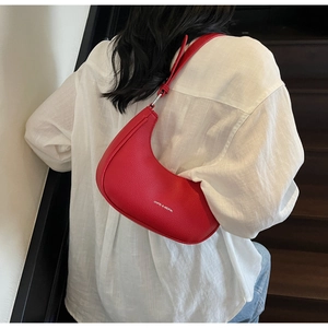 Close-up of a red lychee pattern leather half-moon shoulder bag with white logo logo
