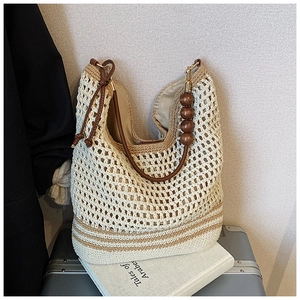 Close-up of woven tote bag with wooden beads and coffee-colored stripes detail