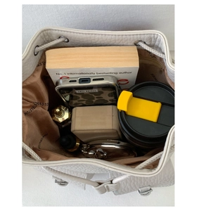 Top view of bucket bag interior showing spacious storage for books and daily essentials