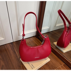 Close-up of red lychee pattern leather hobo bag with silver hardware and logo detail