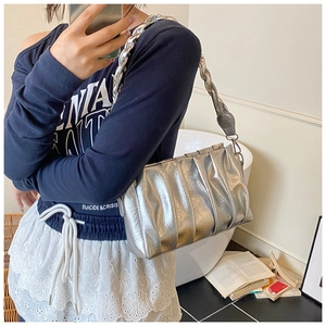 Close-up of a silver pleated shoulder bag featuring a chunky metallic chain strap