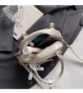 Interior view showing the large capacity of the beige ballet style handbag with ribbon