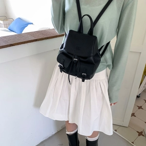 Detailed view of mini black lychee leather backpack with front buckle pockets and drawstring