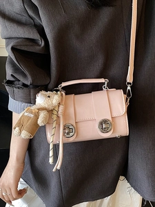 Pink glossy leather crossbody pillow bag with cute bear charm and silver twist locks