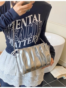 Silver pleated cloud bag with metallic chain strap for modern crossbody or shoulder wear