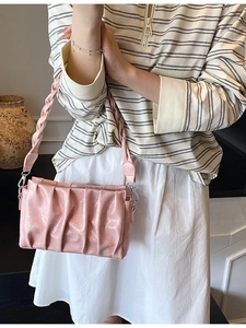 Pink pleated cloud shoulder bag in glossy leather with woven strap and silver hooks