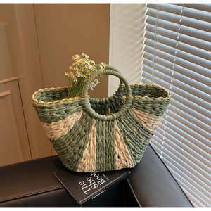 Detail view of contrast weave straw tote bag with round handles and daisy floral decor