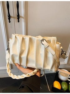 Cream pleated cloud crossbody bag in glossy faux leather with woven handle