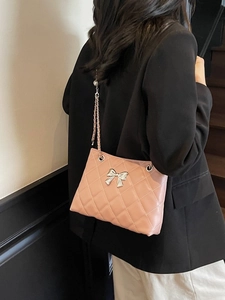 Elegant nude pink quilted shoulder bag with silver bow clasp and chain strap