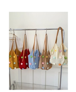 Detail of colorful hand-woven crochet tote bags with 3D flower accents on metal hangers