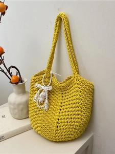 Handmade yellow woven shoulder bag with a cute rabbit charm and soft cotton rope texture