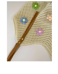 Detail of hand-woven floral tote with colorful 3D flowers and brown leather strap