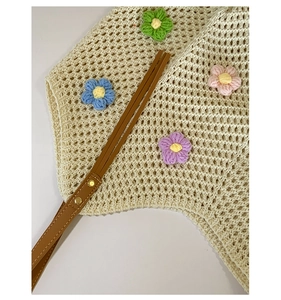 Detail of crochet tote bag with colorful 3D flowers and premium brown leather handle