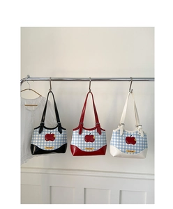 Detailed view of apple-themed plaid shoulder bags in red, black, and white colors