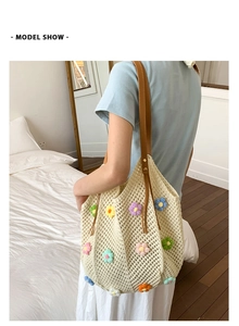 Lifestyle view of a cream crochet tote bag with colorful 3D flowers and leather handles
