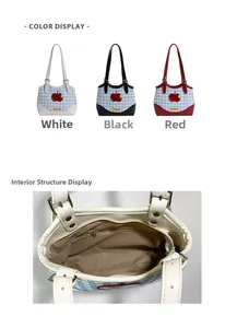 Detail of blue plaid tote bag showing red apple embroidery and inner zipper pocket