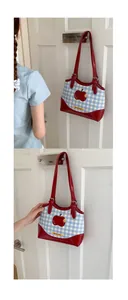Detail of red apple motif and checkered fabric on vintage Korean style tote bag