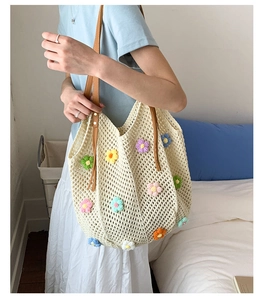 Detailed view of handmade beige crochet tote bag with colorful 3D floral embroidery