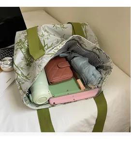 Spacious tote bag with bamboo print showing interior storage for tablets and umbrella