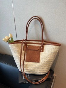 Large beige woven straw tote bag with brown leather accents and tulips decoration