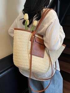 Large capacity woven straw tote bag with brown leather trim and pocket for summer beach