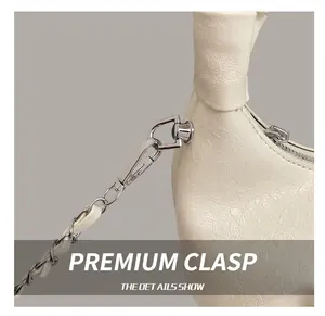 Close-up of premium silver metal hook and textured leopard print leather on white bag